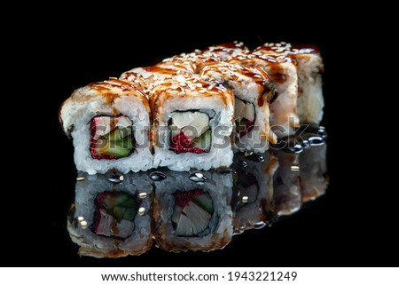 Sushi Roll On A Black Background reflection . Japanese food. Close Up.