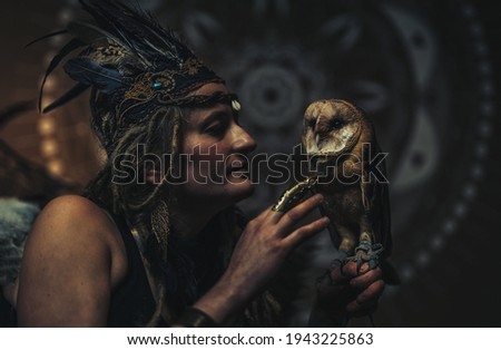 beautiful shamanic woman with owl in the interiors.