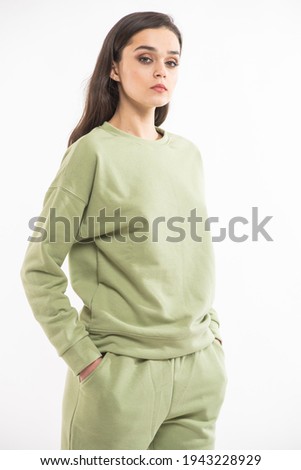 Woman in a warm fleece suit, studio shooting. Casual hoodie