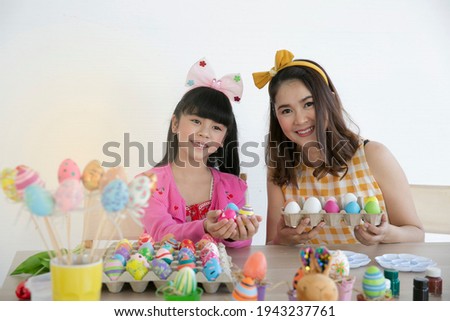 Potrait of mom and child preparing the paited eggs for Easter Holiday. Happy family Happy Easter day.