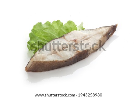 Roasted halibut steak with fresh green lettuce