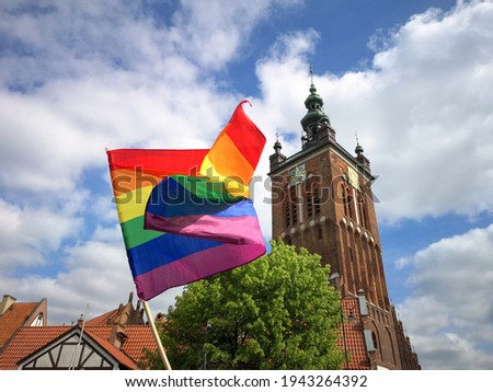 rainbow flag and catholic church in the background in Gdańsk, Poland