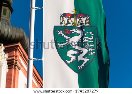 Closeup of the flag of Styria in front of church in Mariazell (Austria), sunny day in springtime