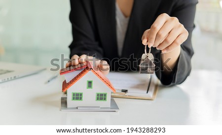 Businessmen and real estate agents introduce clients and negotiate home insurance purchase and sign contracts. Home insurance concept. And selling a home.