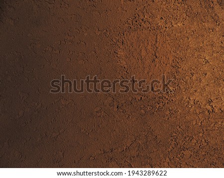 Textured background with shadows and light from the sun. Dark background. Desktop background. Black, gray, and yellow. Venetian plaster.