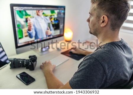 Work from home. A man dedicated to working and edits photos were taken on the set. Production of materials for advertising and a private collection of photographs