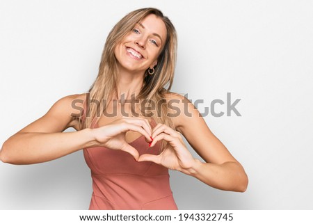 Beautiful caucasian woman wearing casual clothes smiling in love doing heart symbol shape with hands. romantic concept. 