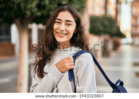 Young middle east student girl smiling happy standing at the city. Royalty-Free Stock Photo #1943323807