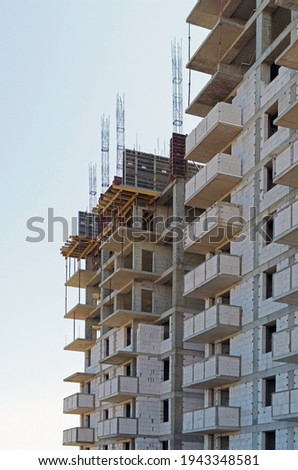 The facade of modern residential building under construction. The construction of modern apartment buildings