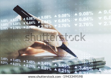 Abstract creative stats data concept with woman hand writing in notebook on background. Multiexposure