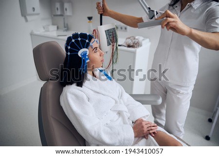 Young lady sitting in the chair during the EEG procedure