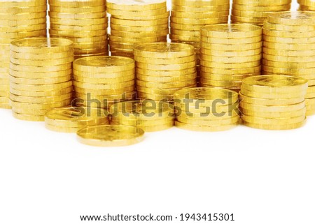 Gold towers made out of gold coins over white background