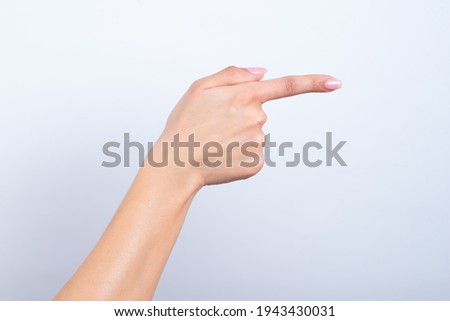 Woman's hand touching or pointing to something isolated on white background. Close up. High resolution.