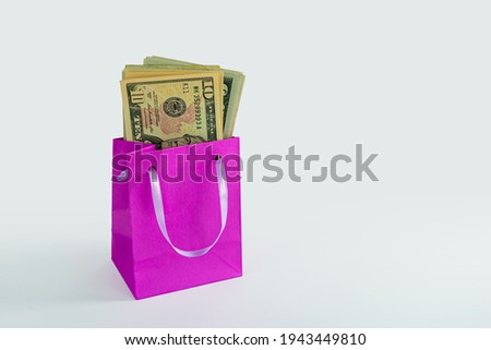 shopping bag filled with US dollar banknotes isolated on white background, shopping spending concept