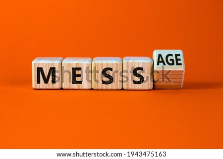 Make your mess your message symbol. Turned cubes and changed the word 'mess' to 'message'. Beautiful orange background, copy space. Business and make your mess your message concept.