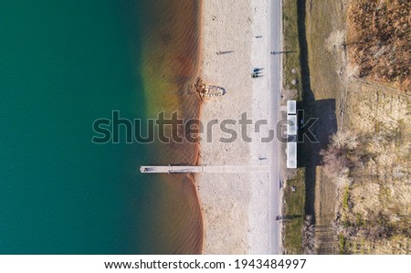 jetty on the beach of a lake
