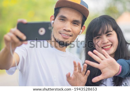 Asian couple use phone selfie  take photo