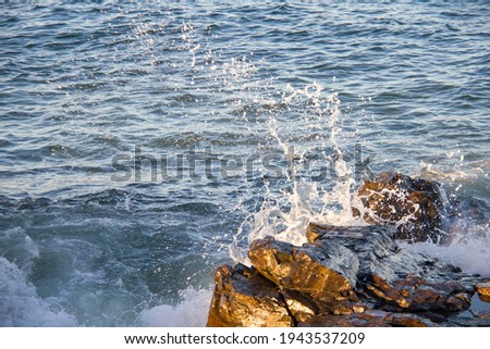 Water motion crashing into rocks still motion