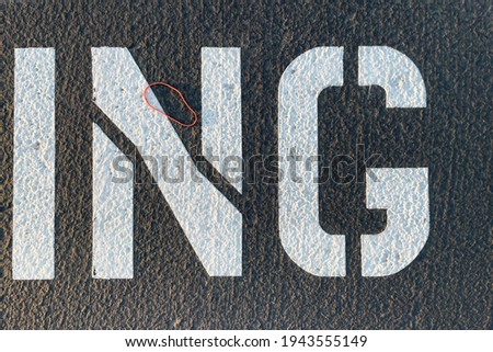 I N G Lettering Road Markings Painted on Asphalt