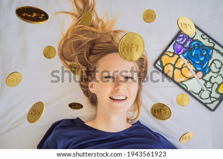 NFT Young woman, a digital artist, creates digital art on a tablet at home and shows a coin with the inscription NTF - non fungible token. Remote work, digital nomad, digital painting, animation