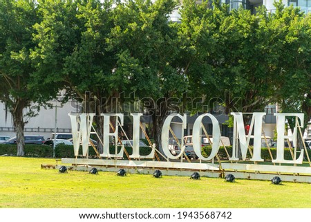 giant word welcome stand in modern tourist city.