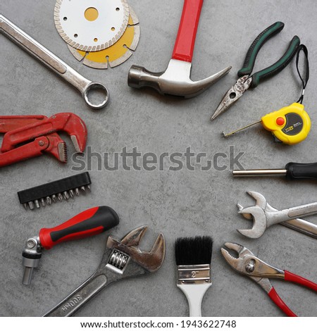 Various work tools on cement background. Flat lay, top view                              