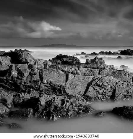 Art of black and white image.Amazing nature of unique rocks formation and beautiful morning light at Terengganu, Malaysia. long exposure. shot. soft and grain image.