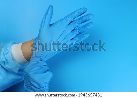 doctor or nurse puts latex gloves on hands