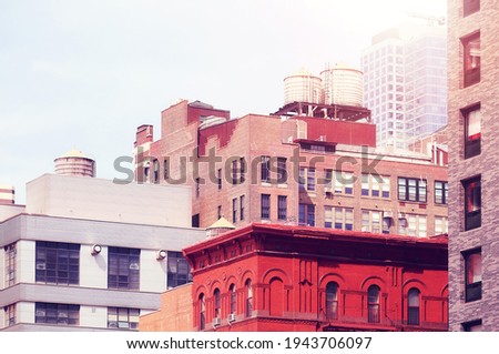 Water towers on New York buildings, color toning applied, USA.