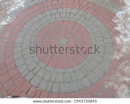 urban street tile design: multi-colored circle of red and gray tiles