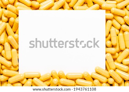 Blank white paper with yellow drug capsules. No clipping path.