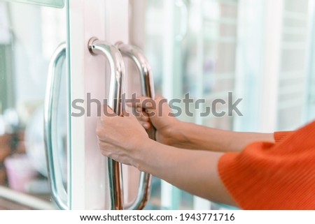 Woman's hand Opening glass door