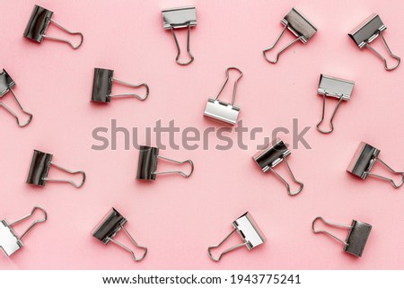 Flat lay of paper binder clips, office supplies pattern