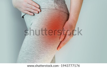 A woman suffers from piriformis syndrome, pain in buttocks muscle caused by sciatic nerve irritation Royalty-Free Stock Photo #1943777176