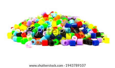 Small pieces of colored plastic. Heap of colorful plastic polymer granules isolated on white