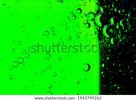 Oil bubbles on the water surface in motion, on a light green background, macro, splash screen, template, copy space