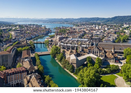 Aerial view of the Limmat river that flow through the Zurich city center by the national museum, the train station and the old town to finish in lake Zurich on a sunny summer day Royalty-Free Stock Photo #1943804167
