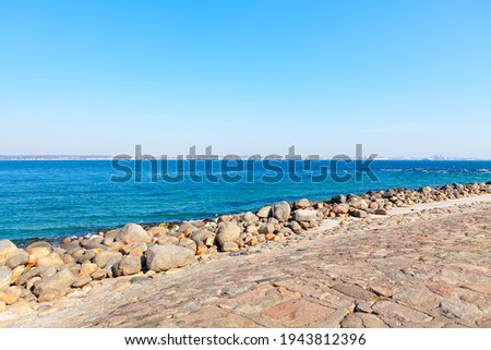 Breakwater giant boulders . Coast of Oresund bay between Denmark and Sweden Royalty-Free Stock Photo #1943812396