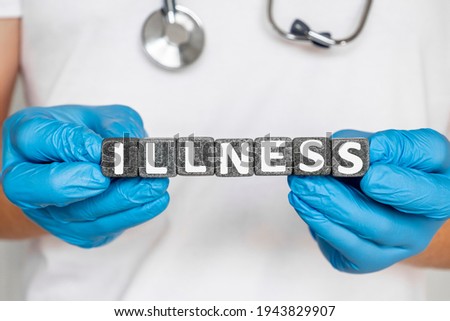 illnes - word from stone blocks with letters holding by a doctor's hands in medical protective gloves. disease or period of sickness affecting the body or mind.