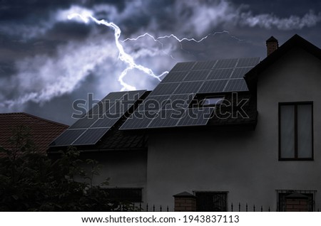 Dark cloudy sky with lightning over house. Stormy weather