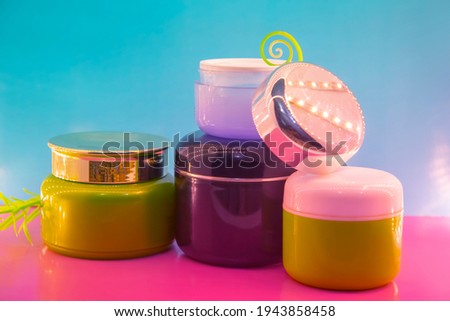 Different makeup cosmetics and accessories on a pink and blue background.Make Up Beauty Fashion Concept