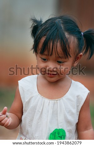 Portrait of asian baby girl, a cute face,Walking in the front yard