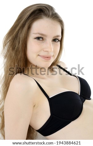Teenage girl wearing a black bikini in studio isolated on white