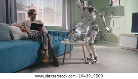 Robot preparing coffee for owner Royalty-Free Stock Photo #1943915500