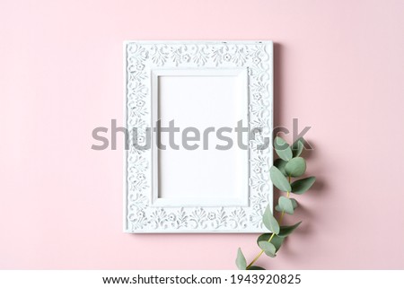 Vintage picture frame mockup and eucalyptus leaf on pink background. Mother's Day greeting card template.