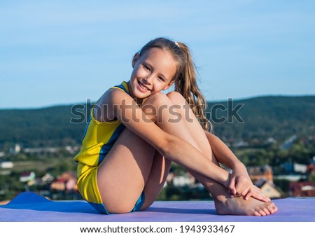 cheerful child athlete or gymnast relax outdoor, fitness