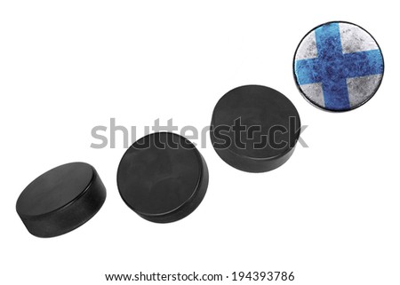 Finnish hockey pucks lined up in a row on white background