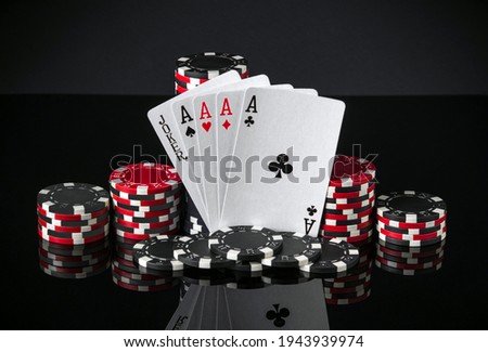 Poker cards with five of a kind the highest combination. Close-up of playing cards and chips in poker club. Free advertising space
