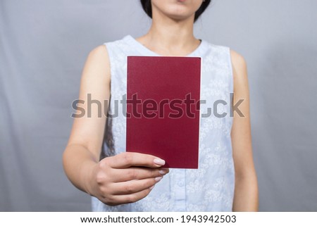 girl reading a book on a gray background
