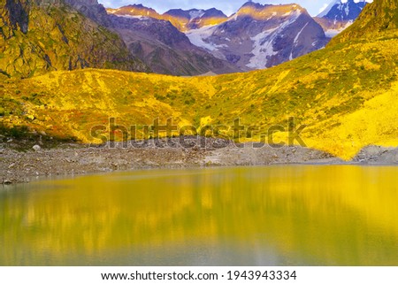 Sunset on Lake Bashkara against the background of the Caucasian Wall in the Elbrus region